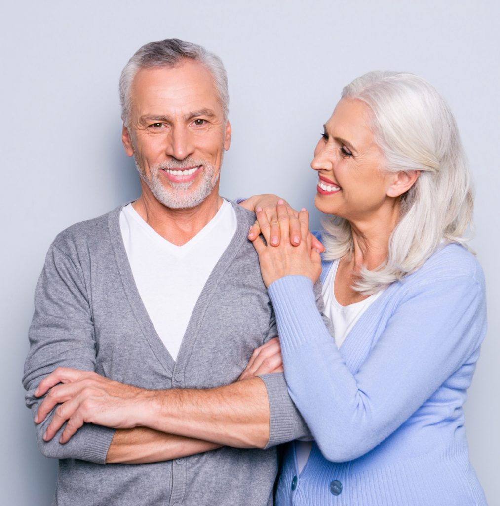 elderly couple smiling about affordable dental implants