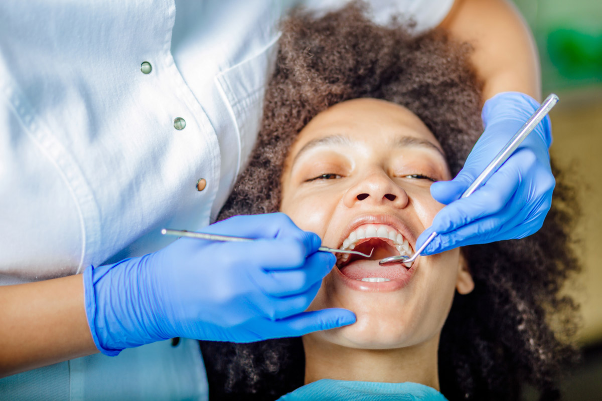 Woman having teeth examined at dentists for overall oral health