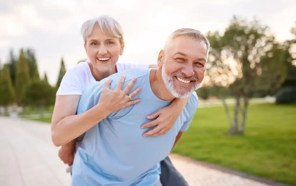 Older Couple Standing Outside Smiling