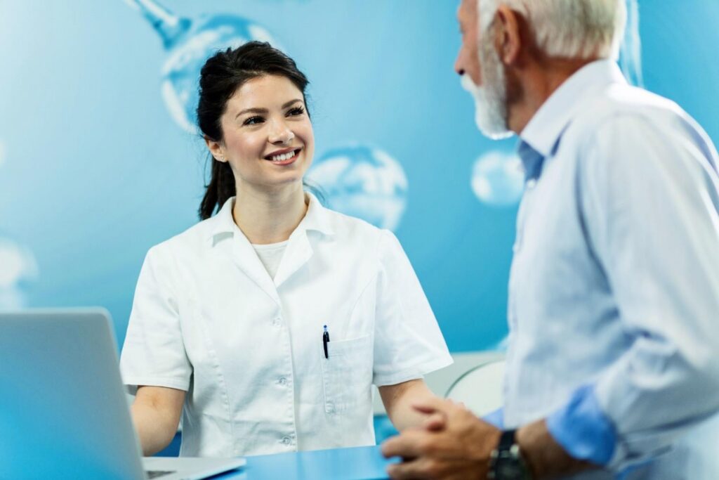 Dentist consulting with an older patient in a clinic.
